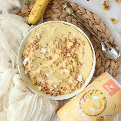 Gelbe Mango Nicecream mit Granola und Kokoschips
