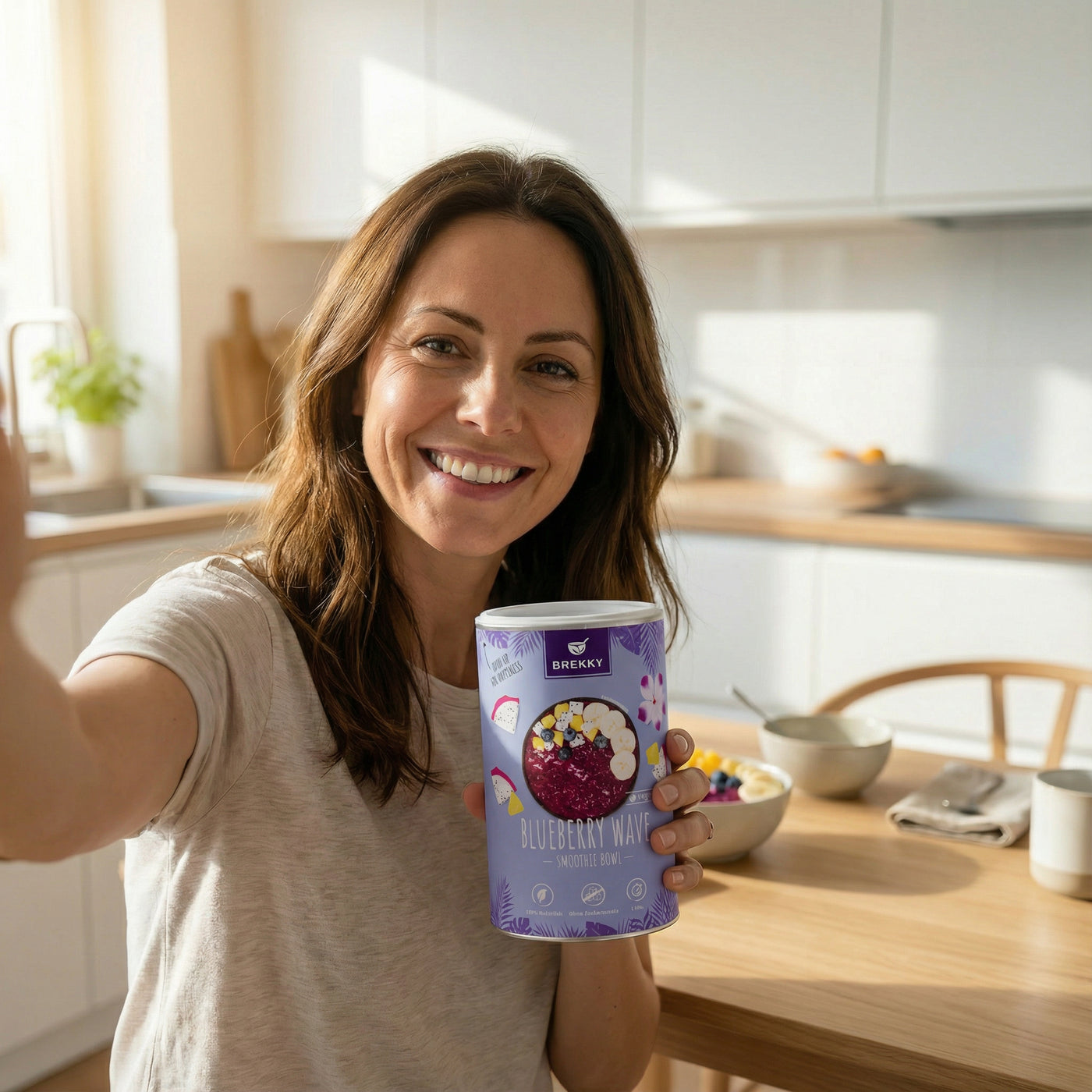 Frau in Küche hält Blueberry Wave Dose