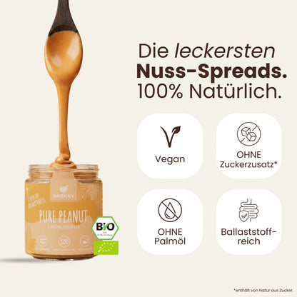 Löffel mit Pure Peanut Erdnussmus über Glas